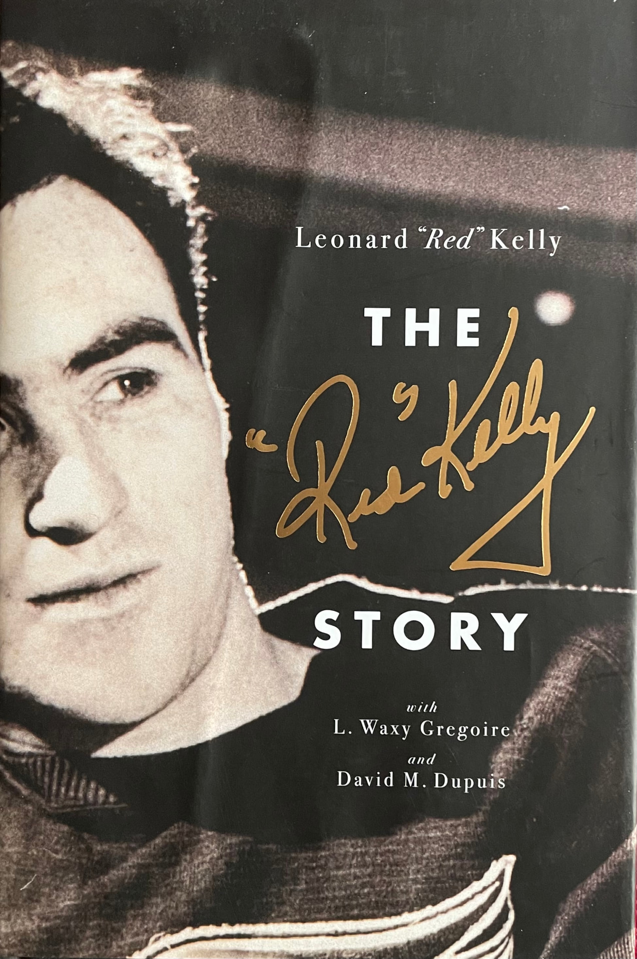 Cover of The Red Kelly Story: Leonard “Red” Kelly with L. Waxy Gregoire and David M. Dupuis — a black-and-white portrait of Red Kelly beside a black panel with the title in gold script