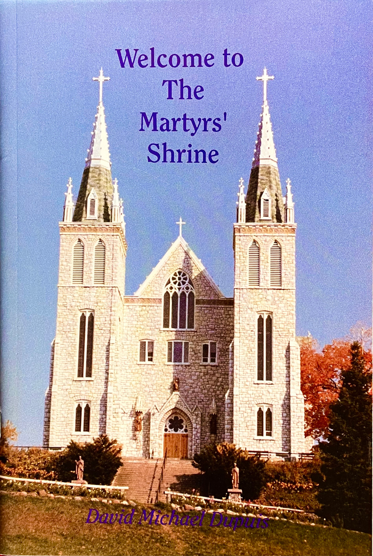 Cover of Welcome to The Martyrs’ Shrine — the twin-spired stone shrine above its hillside gardens