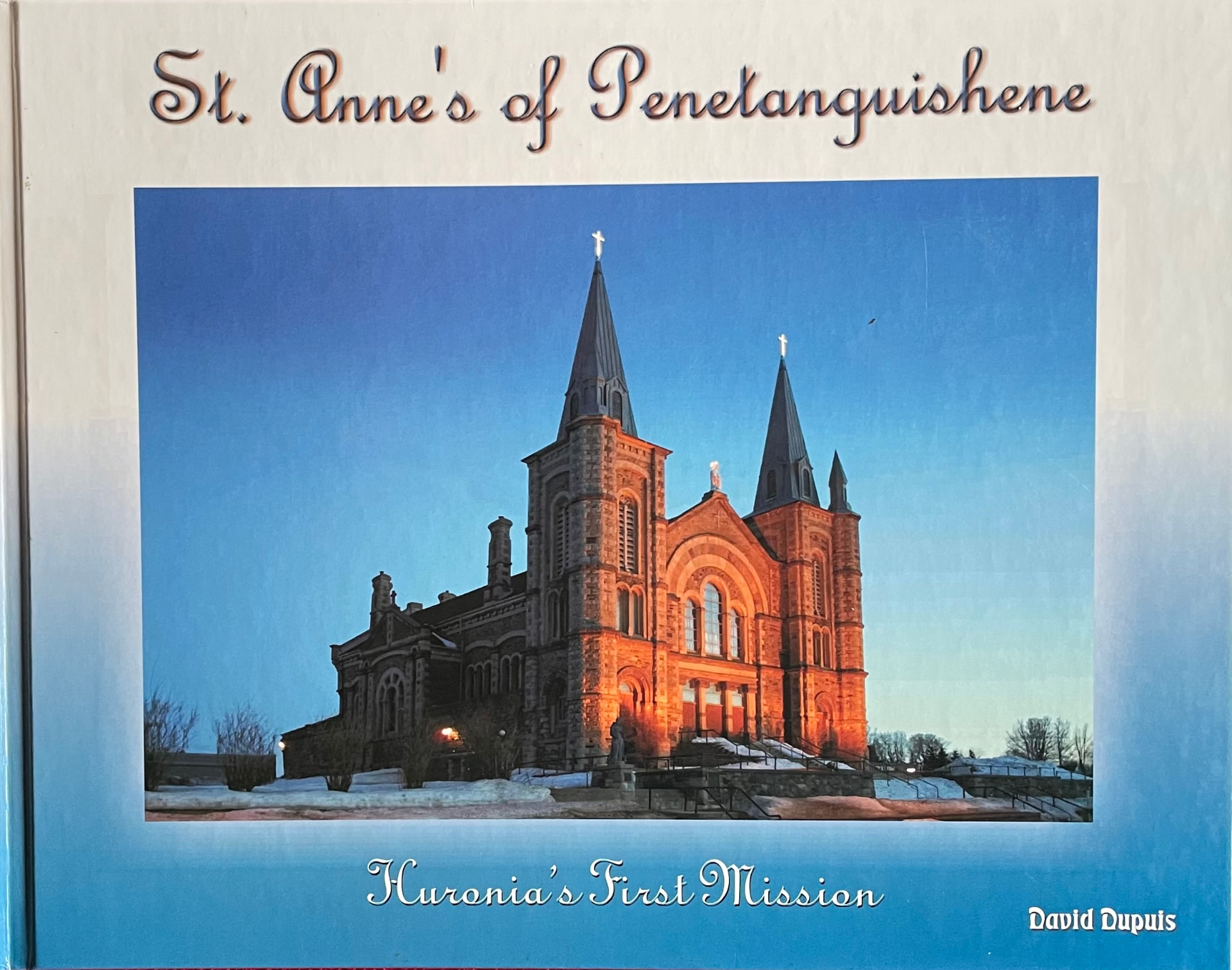 Cover of St. Anne’s of Penetanguishene: Huronia’s First Mission — the church lit by sunset above the snow